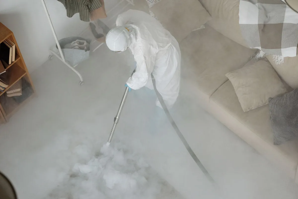 Biohazard cleanup technician in protective equipment, Herington, KS